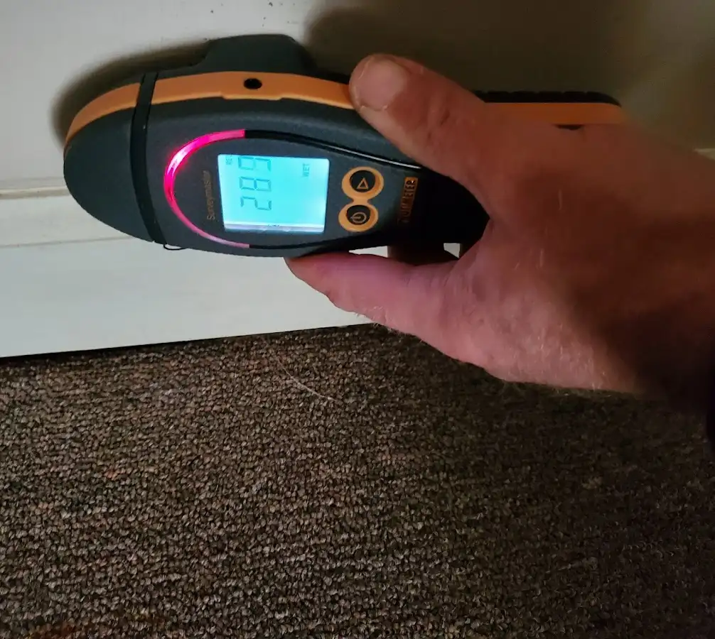 Moisture detection at baseboard during Storm Damage Restoration in Avon